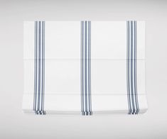 two blue and white striped curtains hanging on a wall