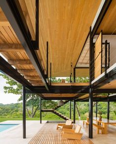 the inside of a house with wooden flooring and stairs leading up to an outdoor swimming pool