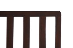 a baby crib with wooden slats on the top and bottom rails, in dark wood