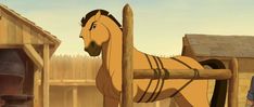 a horse standing next to a wooden pole