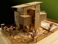 a model of a house with birds flying around it