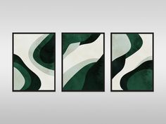 three green and white abstract paintings hanging on a wall in front of a gray background