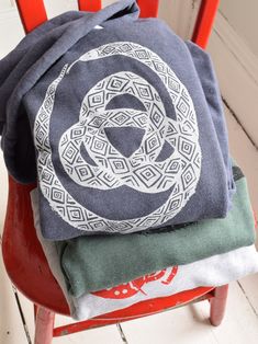 This super soft sponge fleece pullover hoodie is hand printed with our original Ouroboros design in our home studio on the Coast of Maine. It features kangaroo pockets, ribbed cuffs and waistband, has a hood drawstring and is pre-shrunk. Details: * Original Hearth and Harrow Snake design, printed in white * Bella + Canvas Sponge Fleece Hoodie in navy/grey * Eco-friendly, water-based ink * Unisex sizing * Machine wash cold, tumble dry The handmade quality of our products assures that each one is Vans Hoodie, Snake Design, Fleece Hoodie, Bella Canvas, Pullover Hoodie, Sweatshirts Hoodie, Adult Outfits, Design