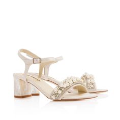 a women's white sandal with pearls on the heel