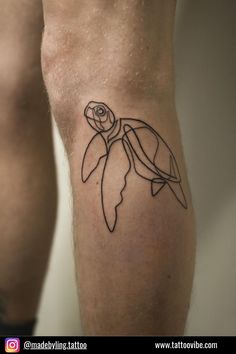 a man's leg with a tattoo of a turtle on it