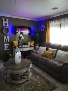 a living room filled with furniture and flowers on top of a table in front of a window