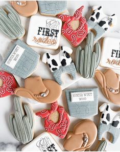 decorated cookies are arranged in the shape of cactuses and cowgirl's hats