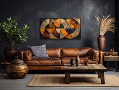 a living room with leather furniture and plants on the side table in front of it