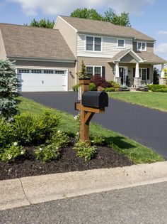 a mailbox sitting in the middle of a driveway