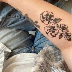 a woman's arm with flowers on it