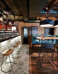 the interior of a bar with stools and tables