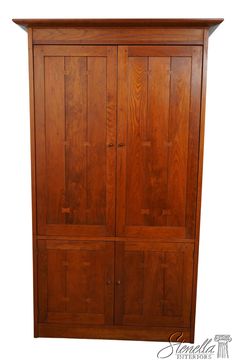 a wooden armoire with three doors and two drawers on one side, against a white background