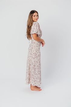 Discover effortless elegance in our charming Lucia Maxi Dress - it's already a favorite here at Worth Collective! This beautiful dress is cut on the bias, ensuring an ultra-flattering and feminine fit. The Lucia's puffed sleeves and flowy skirt only add to its vintage allure, and its gorgeous lilac floral print is spring-ready! Pair with pumps or dainty sandals for an extra-special event. FIT: Runs true to size. Fabric does not stretch; bias cut makes this dress more fitted through the waist and Feminine Fitted Maxi Dress For Brunch, Chic Floral Print Maxi Puff Sleeve Dress, Chic Puff Sleeve Maxi Dress With Floral Print, Chic Floral Print Puff Sleeve Maxi Dress, Chic Puff Sleeve Floral Maxi Dress, Modest Spring Dresses With Fitted Bodice, Chic Puff Sleeve Maxi Dress For Garden Party, Modest Fitted Puff Sleeve Summer Dress, Chic Maxi Puff Sleeve Dress For Garden Party