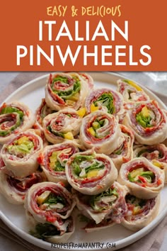 a white plate topped with rolls filled with meat and veggies