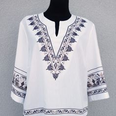 "Experience the freedom and style of our Large Hippie Blouse. Crafted with love and attention to detail, this boho top blouse is the perfect addition to your summer wardrobe. With exquisite embroidery and vibrant colors, it exudes a carefree and joyful vibe that is perfect for any hippie festival or a casual outing. Made from high-quality materials, it offers both comfort and durability. Embrace the bohemian spirit and make a statement with our women's embroidered summer shirt. Elevate your fashion game and feel confident in this unique and eye-catching piece of clothing. Get ready to turn heads and stand out from the crowd with our trendy hippie festival clothes. Very beautiful white with brown/beige colors vintage blouse. Has a producer label. Half long sleeves. A side small slits. The f Bohemian V-neck Embroidered Top, Folk Style V-neck Blouse With Embroidered Neckline, Summer Embroidered V-neck Peasant Top, Bohemian Cotton V-neck Top, Floral Embroidered Tunic Top For Festival, Bohemian Spring Embroidered Tunic Top, Spring Bohemian Embroidered Tunic Top, Bohemian Tops With Geometric Embroidery For Vacation, Summer Geometric Embroidery Tunic Top