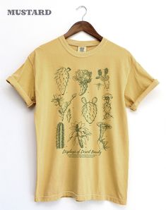 Thanks for checking out this Cactus & flowers Botanical T-shirt in an encyclopedia aesthetic. An eclectic arrangement of succulents and desert wildflowers in a line art style makes for a smart looking diagram style graphic. The Subtle colored artwork is on a beautiful selection of garment dyed Tees.  the Comfort Colors 1717, The soft-washed, garment-dyed fabric has a weathered vintage look that hold up well, but soften over over time for a warm look. This fully customized tee is made 100% with r Encyclopedia Aesthetic, Cactus And Flowers, Plant Tshirt, Cacti Art, Botanical Tshirt, Desert Wildflowers, Flowers Botanical, Cactus Art, Art Shirt