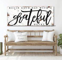 a wooden bench sitting in front of a white wall with the words gather on it