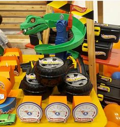 an assortment of toy vehicles on display in a store with children's toys nearby