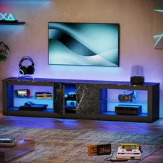 an entertainment center with blue lights and headphones on the shelves in front of a flat screen tv