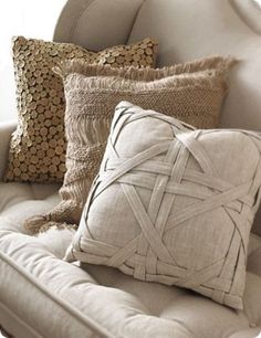 some pillows are sitting on a white couch