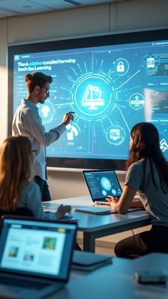 three people sitting at a table in front of a projector screen and laptops