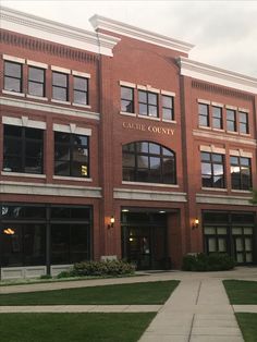 the building has many windows and is red brick with gold lettering that says castle county