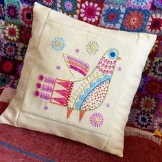 a decorative pillow with a bird on it