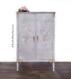 an ornate cabinet with flowers painted on it