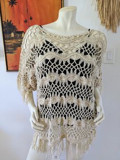 "Vintage Macrame Top Beach Cover Size Large No tags so probably not commercially made. Beautiful detailed work. Feels like cotton but I'm not certain. Would work as a beach cover up or gorgeous as a blouse over a contrasting tank top. No stains or obvious flaws. Ivory/Natural color (not true white) Measurements (laying flat and not stretched) Bust 48\" Waist 48\" Hips 52\" I do my best to represent items accurately. If you would like additional information or photos, I am happy to oblige." Bohemian Woven Beach Poncho, Bohemian Woven Poncho For The Beach, Cream Cotton Crochet Beach Top, Cream Tops With Crochet Trim For Beach, Bohemian Crochet Top For Summer Warm Weather, Cream Cotton Crochet Top For Beach, Cream Cotton Crochet Top For The Beach, Cotton Poncho For Beach Season, Casual Beige Poncho For Vacation