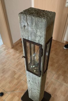 an old fashioned lantern sitting on top of a wooden floor