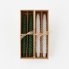 three candles in a box tied with twine and string on the inside one is empty