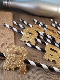 gold glitter elephant straws with black and white striped paper straws