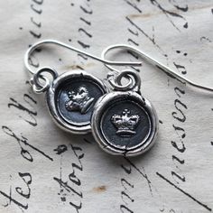 "A dainty pair of wax seal crown earrings, unique and one-of-a-kind, they are handmade in sterling silver using an antique Victorian era wax seal dating to the early 1800's. They come thoughtfully presented and ready for gifting. ►YOUR JEWELRY COMES BEAUTIFULLY GIFT BOXED and INCLUDES a CARD with the CHARMS MEANING & SYMBOLISM, and a CARE CARD! ◄ D E T A I L S: * 925 Sterling Silver * Wax Seal Crown is 3/8\" in diameter * Handmade in the USA > > See OTHER HEART JEWELRY HERE: https://ww Seal Earrings, Wax Seal Initials, Wax Seal Pendant, Wax Seal Jewelry, Wax Seal Necklace, Crown Earrings, Leather Corded Necklace, Charm Necklace Silver, Victorian Women