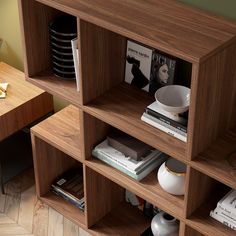 the bookshelf is filled with magazines and other items