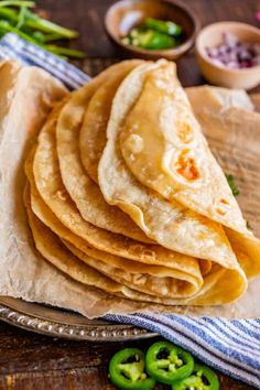 tortillas stacked on top of each other with green peppers