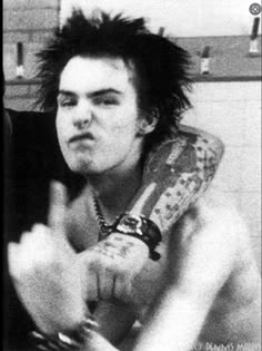 black and white photograph of a man with punk hair