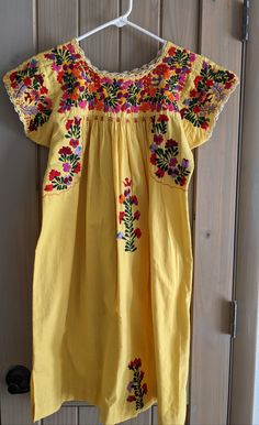 Excellent Vintage Condition. Mexican Oaxacan Dress Embroidered Hippie Boho Mini 70s Long Sleeve Tent Dress Yellow Bohemian Dress. 36 In Long, 19 In Armpit To Armpit. Size Small. Yellow Folk Dress For Spring, Yellow Embroidered Folk Dress, Yellow Folk Style Embroidered Dress, Spring Yellow Embroidered Dress With Short Sleeves, Yellow Floral Embroidered Festival Dress, Yellow Floral Embroidery Festival Dress, Yellow Floral Embroidered Dress, Yellow Floral Embroidered Dress For Festival, Traditional Yellow Embroidered Dress For Spring