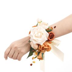 a woman's arm with a wrist corsage and flowers on the side