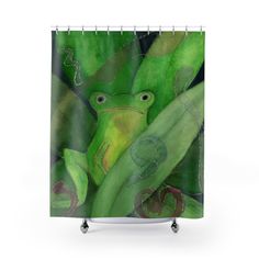 a shower curtain with a green frog on it's back and leaves around it