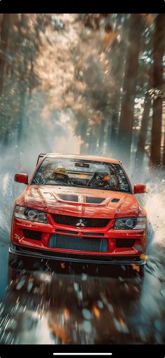 a red sports car driving down a wet road