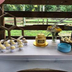 a table topped with cupcakes and other dessert items