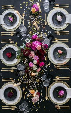 the table is set with flowers and candles