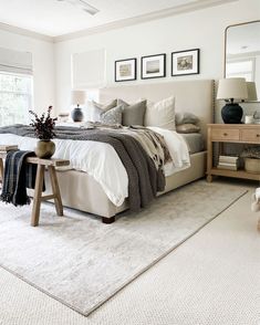 a bedroom with a large bed and white carpet