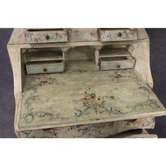 an old fashioned desk with drawers and rug