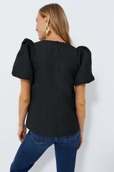 A classic silhouette with scaled-up details, the Black Lyla Blouse is oh so chic. Designed with bubble sleeves for volume and a textured jacquard fabric that adds dimension and makes for a polished finish, this top is a guaranteed wardrobe winner. Classic-with-a-twist, just add denim and heels for an effortlessly glamorous party look! Round neckline Puff at shoulders Bubble sleeves Back keyhole with covered button closure Bust darts Hits at low hip Textured fabric Lined Material: 100% Polyester, Elegant Puff Sleeve Top For Night Out, Elegant Puff Sleeve Top With Structured Shoulders, Elegant Black Structured Top, Elegant Black Puff Sleeve Top, Elegant Fitted Top With Padded Shoulders, Elegant Fitted Tops With Padded Shoulders, Elegant Tops With Blouson Sleeves, Black Structured Top For Formal Occasions, Textured Fitted Short Sleeve Top