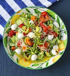 zucchini noodle salad with tomatoes, cucumbers and parmesan cheese