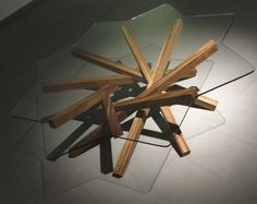 a glass table topped with lots of wooden sticks