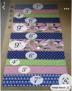 several strips of fabric with numbers and animals on them, all laid out in the same row