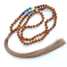 5mm Rudraksha with (7 chakra 5mm beads) Garnet, Red Onyx, Citrine, Green Onyx, Turquoise, Amethyst, Lapiz Lazuli.  The mala is finished off with beautiful tassel.  108 beads + Guru ( 5mm Red Onyx). Length(drop) approx 14 inch excluding tassel. Guru+tassel - 7 inch approx. Multicolor 108 Beads Mala For Meditation, Multicolor Mala With 108 Beads For Meditation, Spiritual Multicolor Beaded Necklaces For Rituals, Bohemian Mala With Colorful Beads For Meditation, Multicolor 108 Beads Necklaces For Rituals, Adjustable Mala With Natural Stones And Round Beads, Adjustable Multicolor Gemstone Beads Mala, Multicolor 108 Beads Mala As Gift, Multicolor Beaded Mala For Meditation