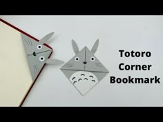 two origami rabbits made out of paper with the words totoro corner bookmark